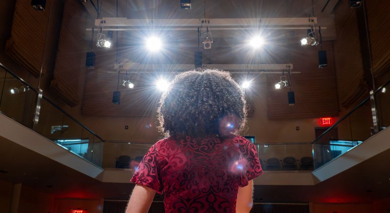 singer on stage photographed from behind