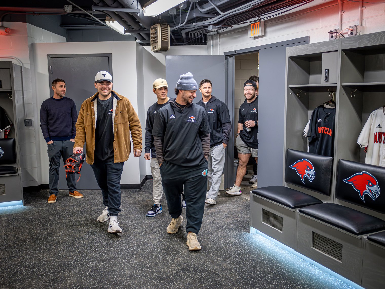 Players tour a locker room.