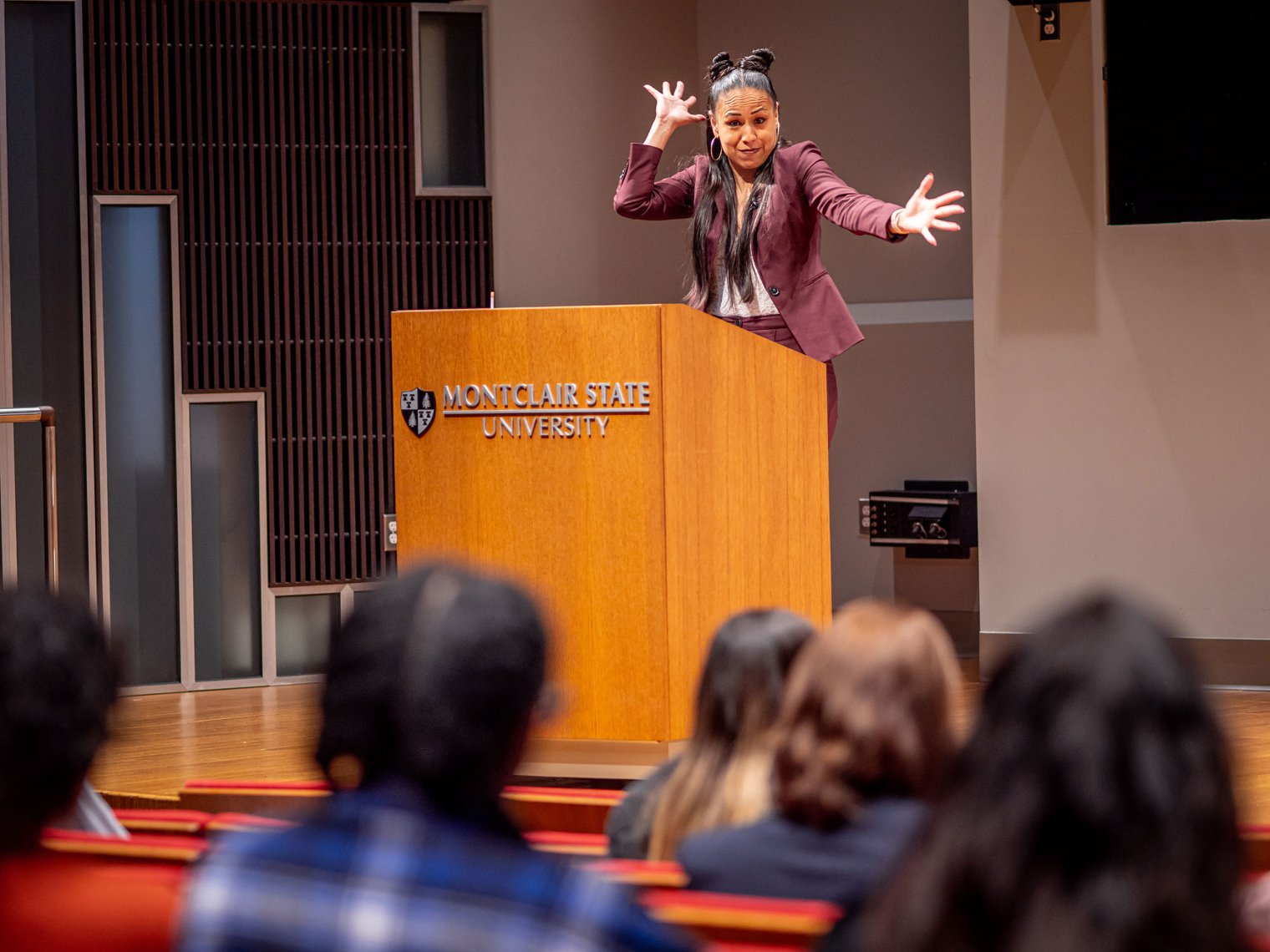 A woman named Gina Garcia gestures from behind a podium