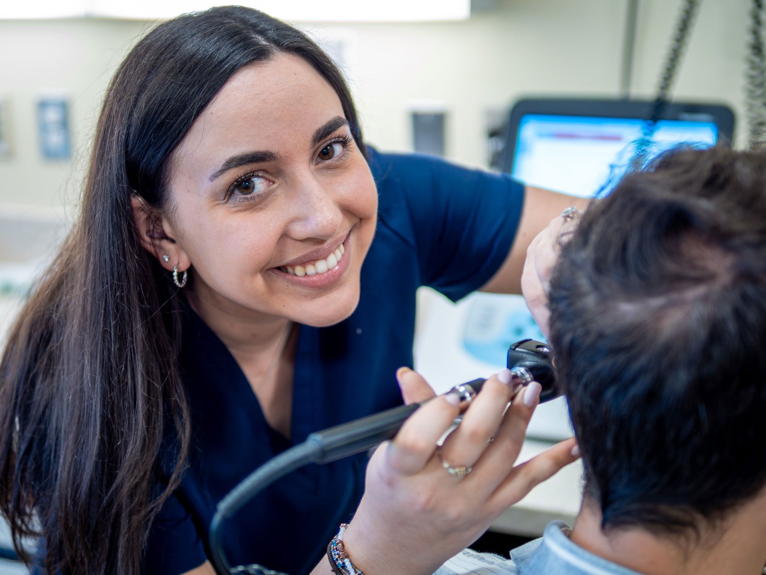 Grace Gleba examines a patient at Montclair’s Audiology Clinic.