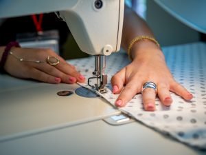Sewing machine is shown being used. 