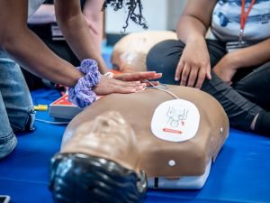 Dummy used for CPR training is being used. 