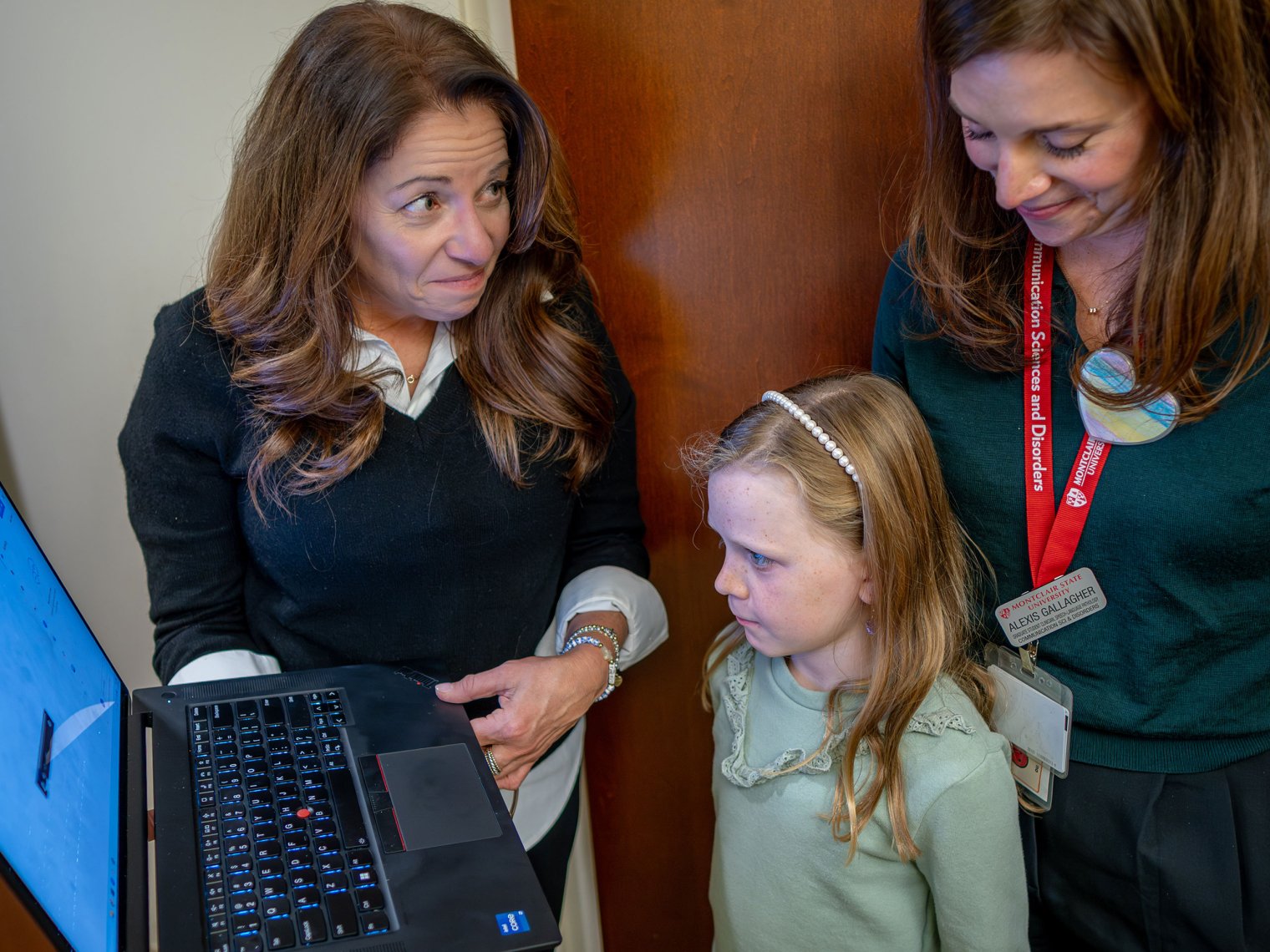 Elaine Hitchcock and Gallagher show Colette the progress she’s made on a laptop computer.