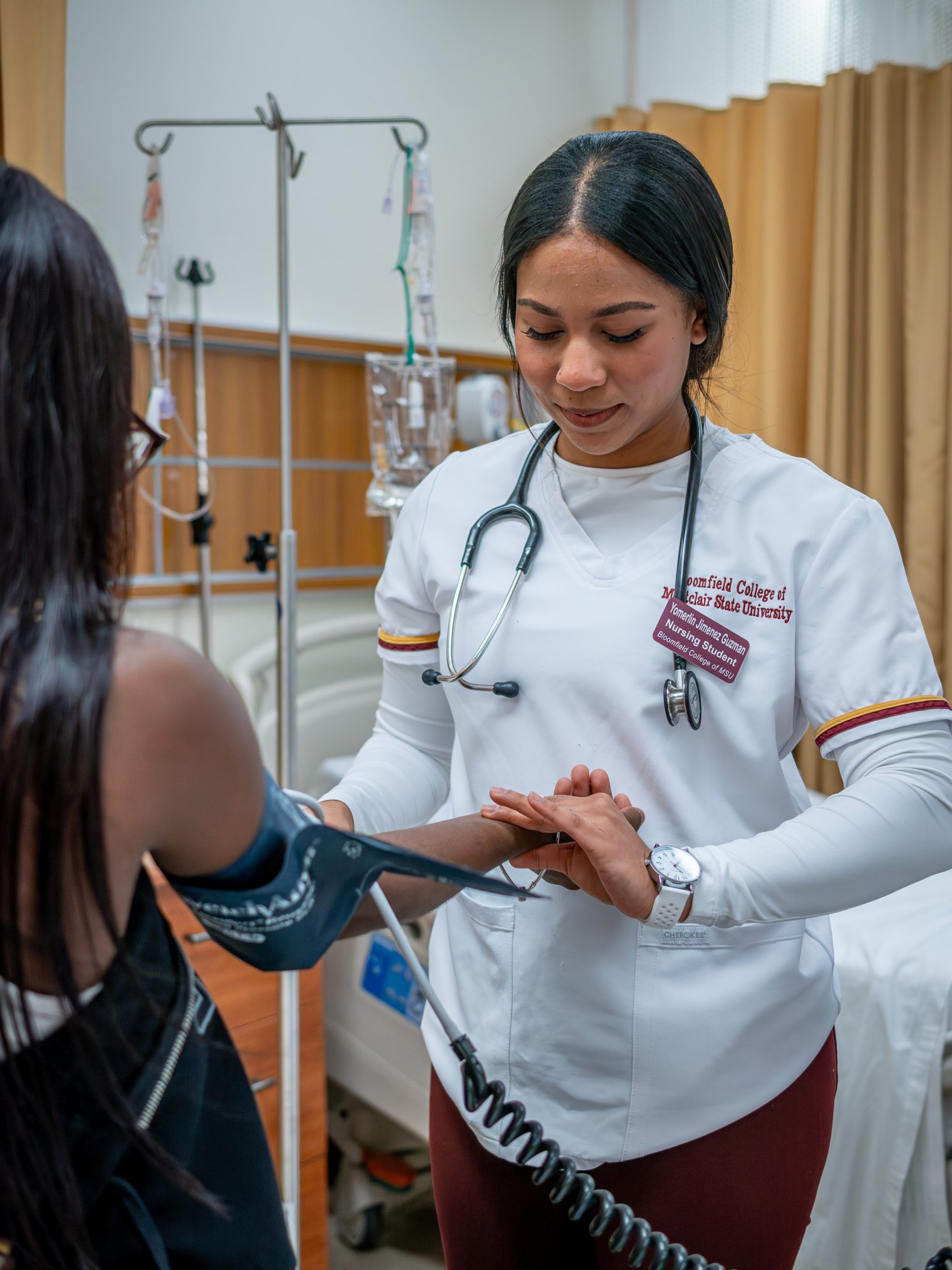 Woman is pictured taking the blood pressure of another woman. 