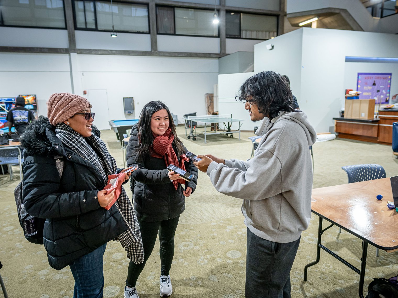 Mahir Ahmed scans student IDs outside the Red Hawk Pantry.
