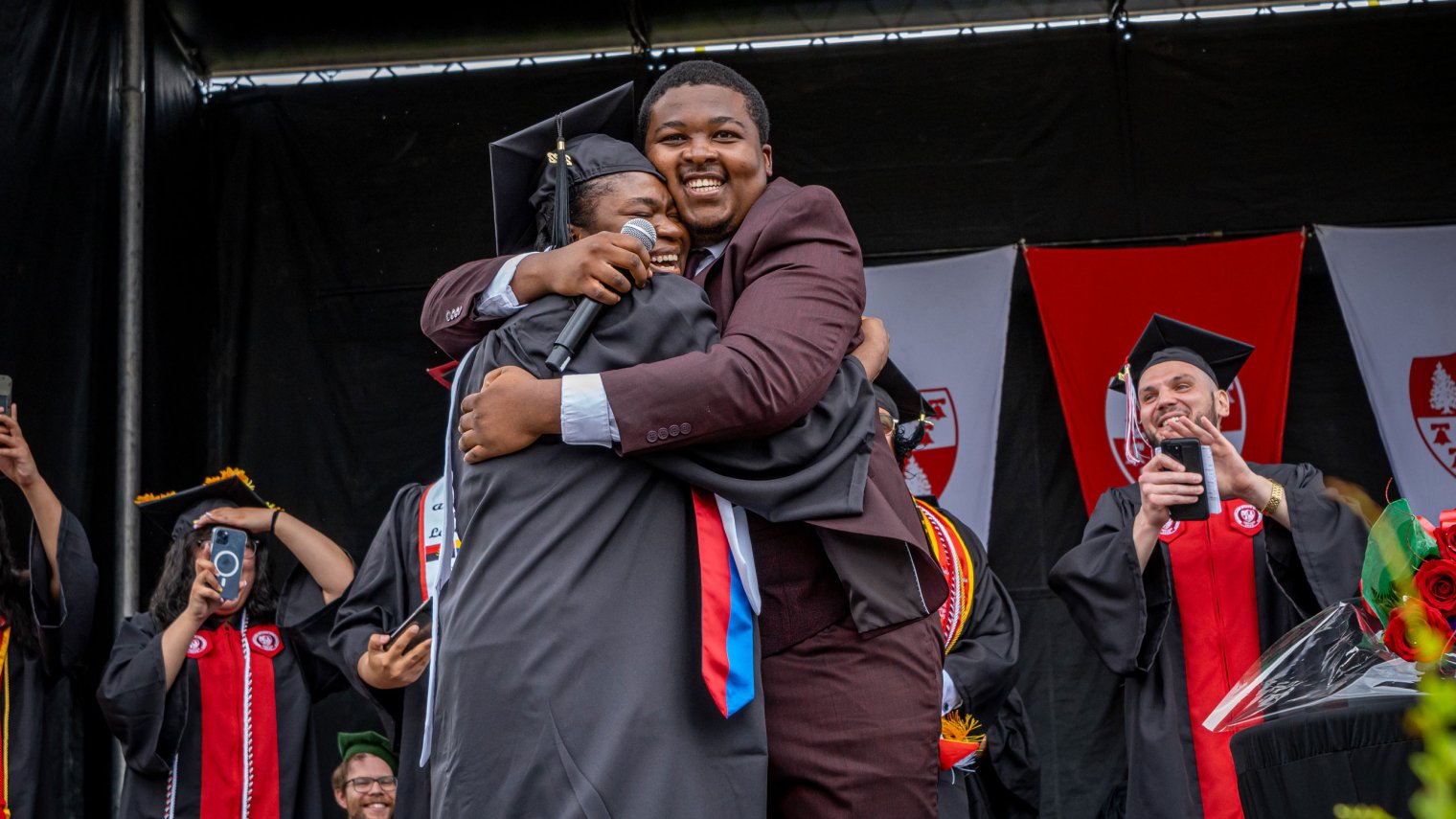 Joseph and Fevrius embracing on stage