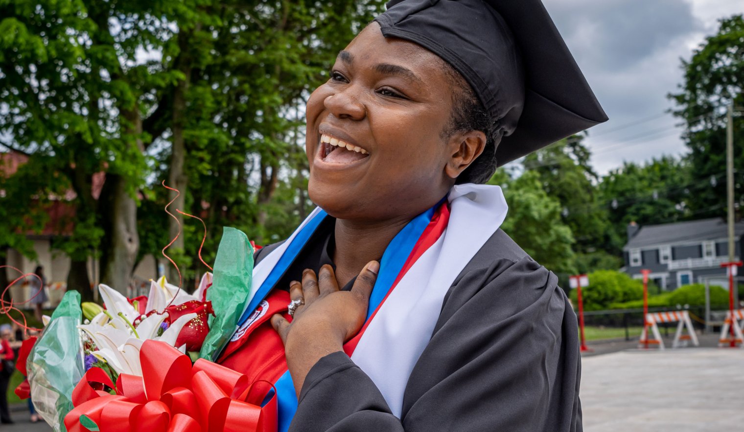 Fevrius walking on campus after convocation laughing