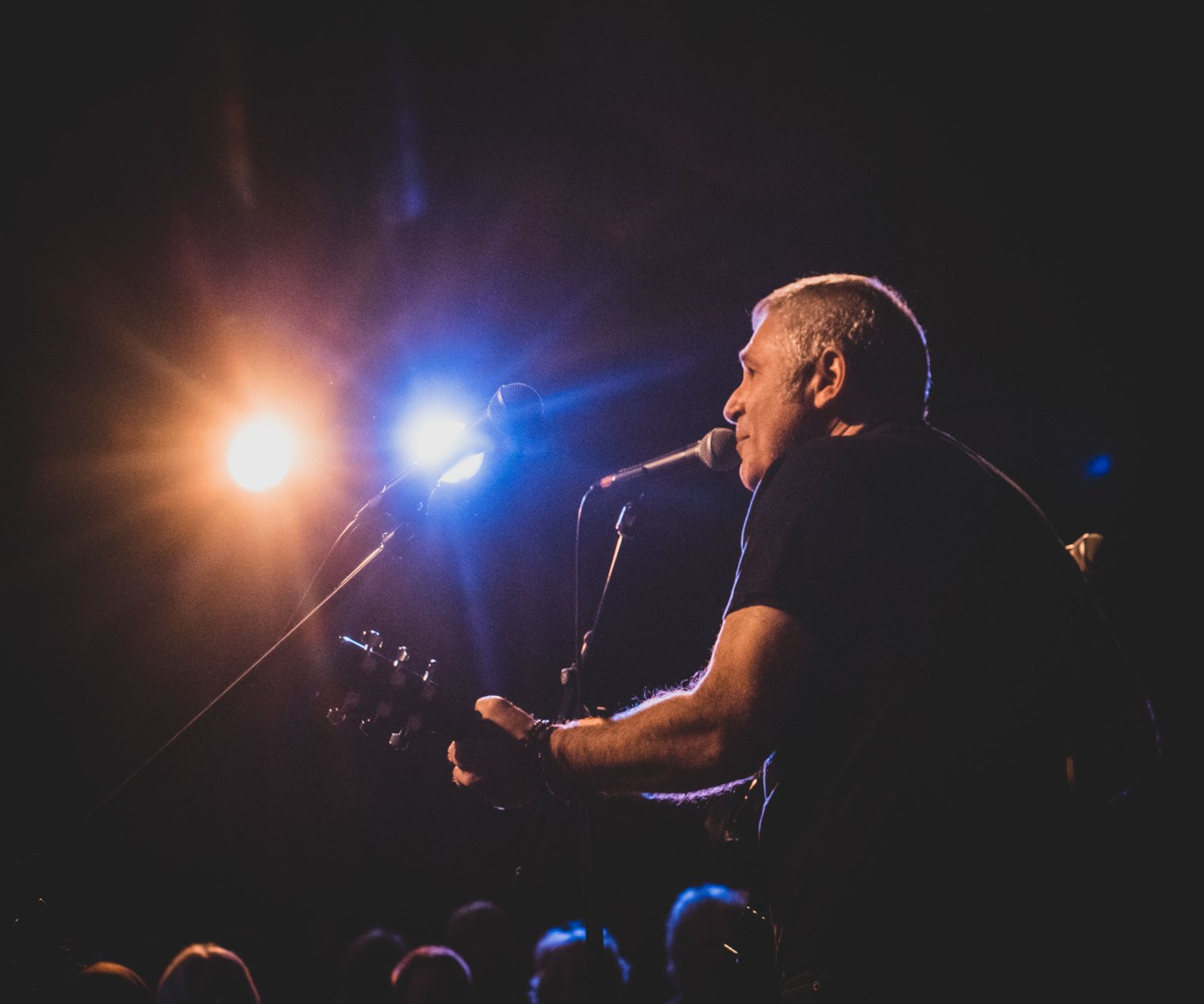 Jon Caspi sings and plays guitar onstage.
