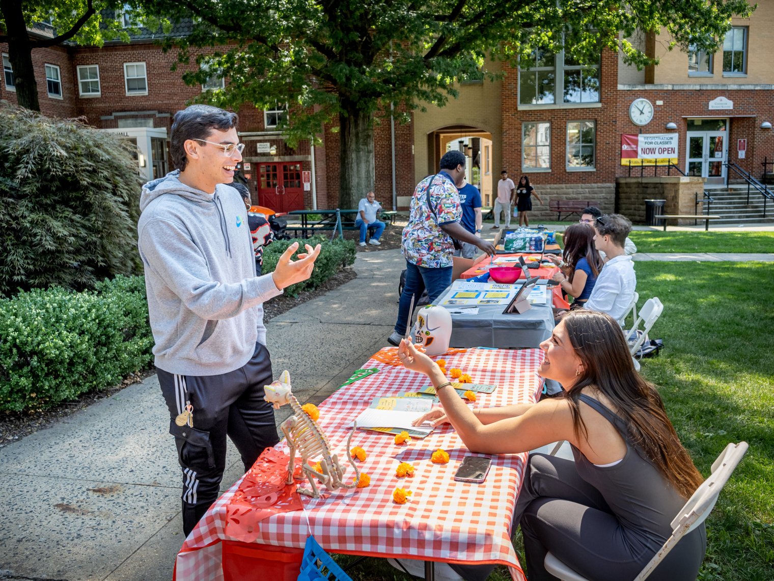 Man and woman seen discussing, laughing over a table.