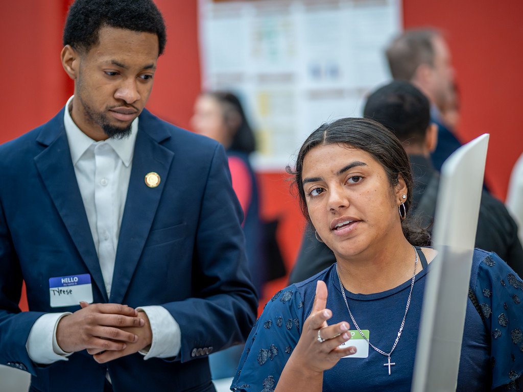 Woman explaining something to another man. 