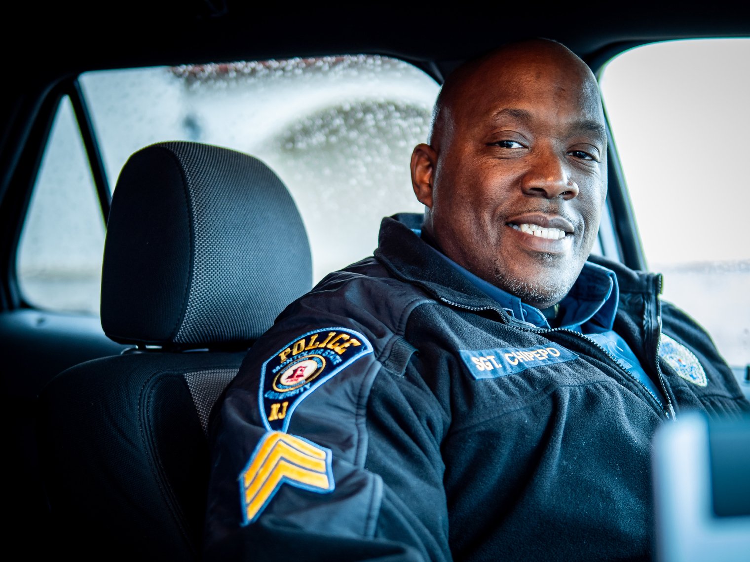 MSUPD officer in his car smiling.