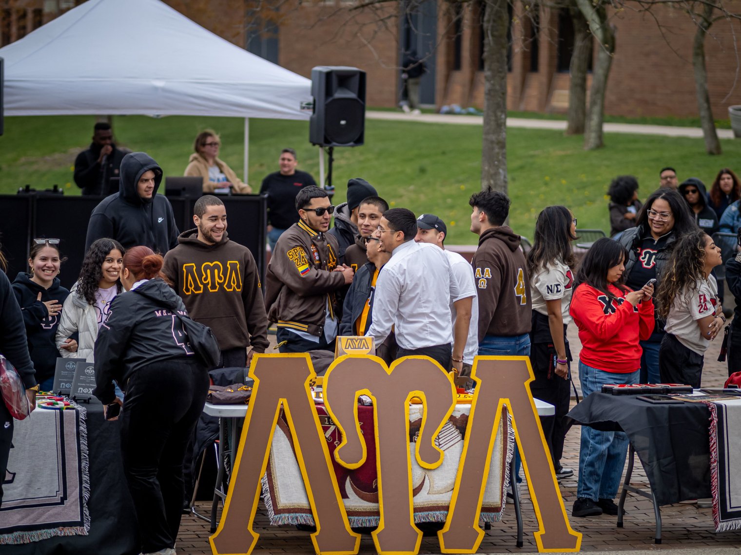 Students behind of a Greek Life table.
