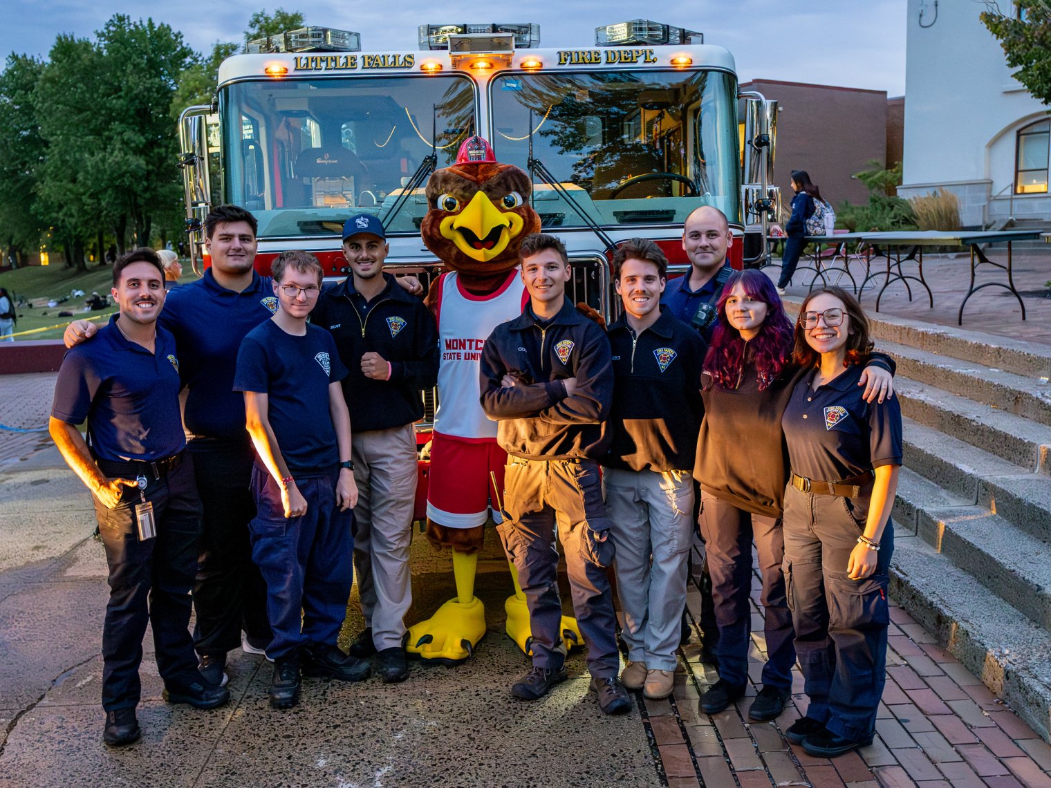 Group of students with Rocky in front of a fire truck.