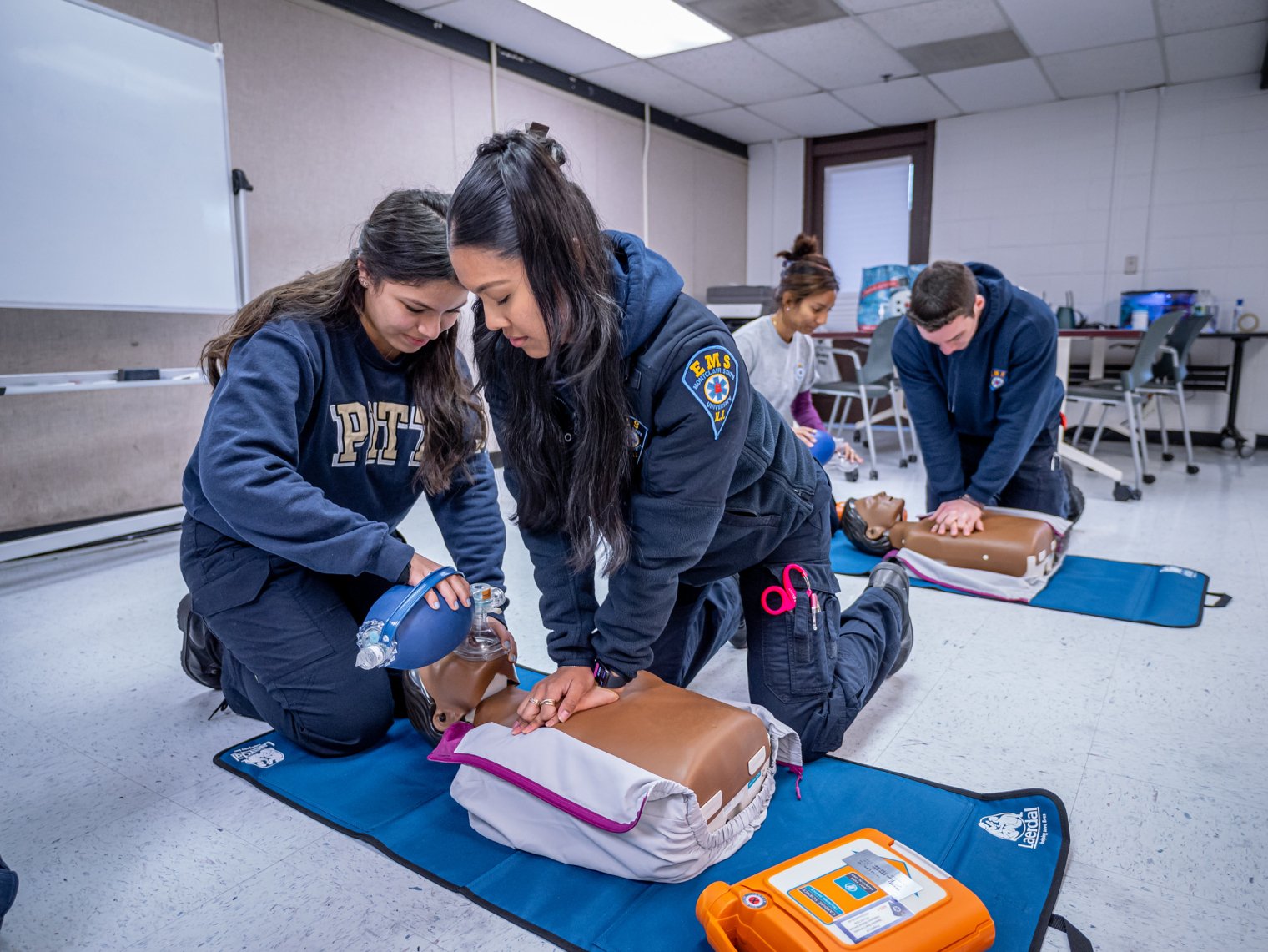 EMS students practicing on a dummy.