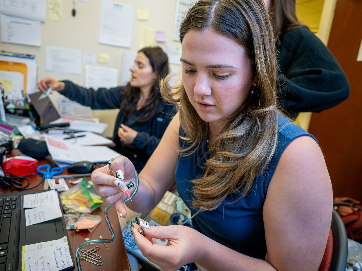Emma Simas tests hearing aids at Montclair’s NJ Hearing Aid Project office.