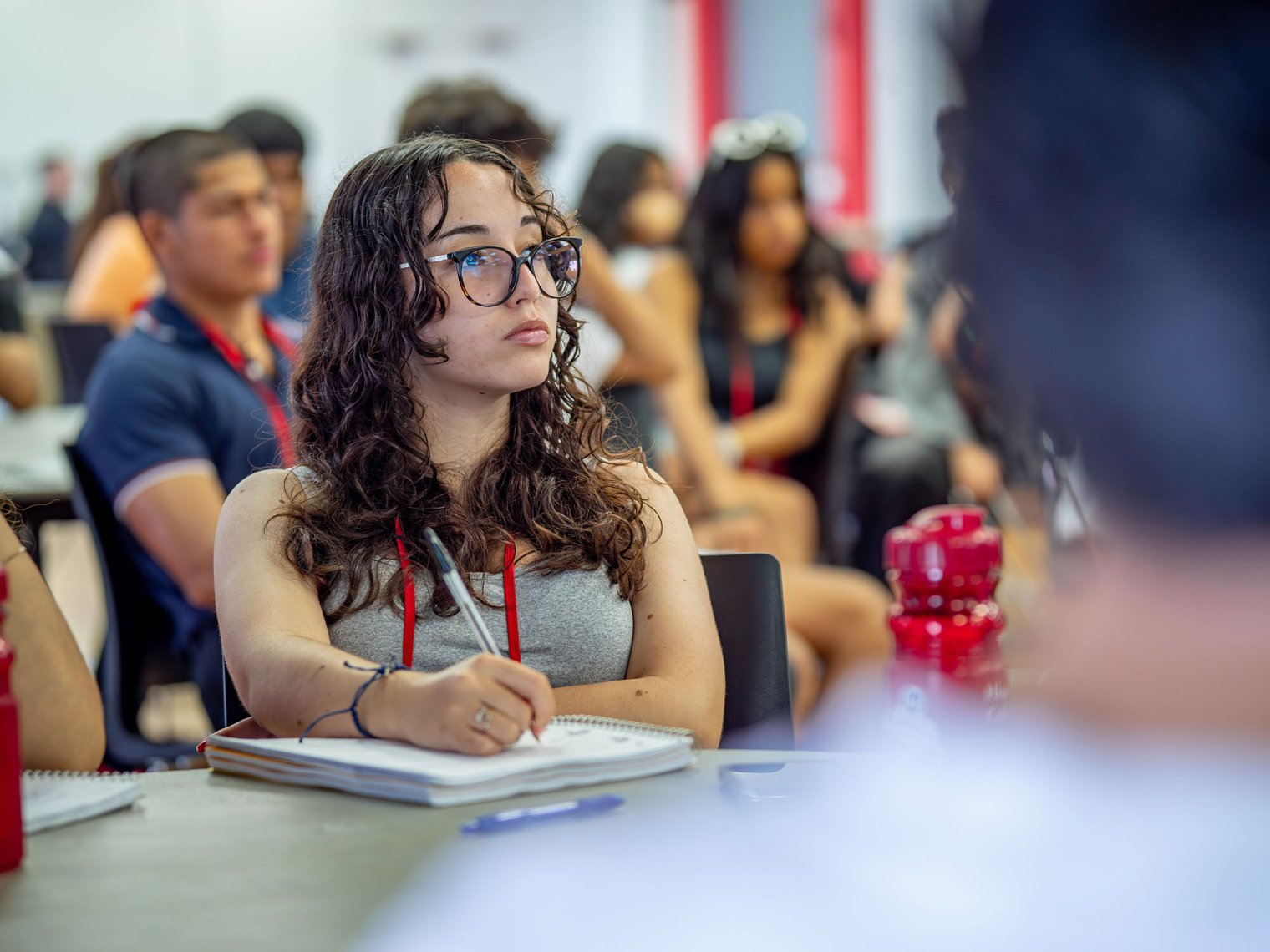 Student taking notes during a conference.