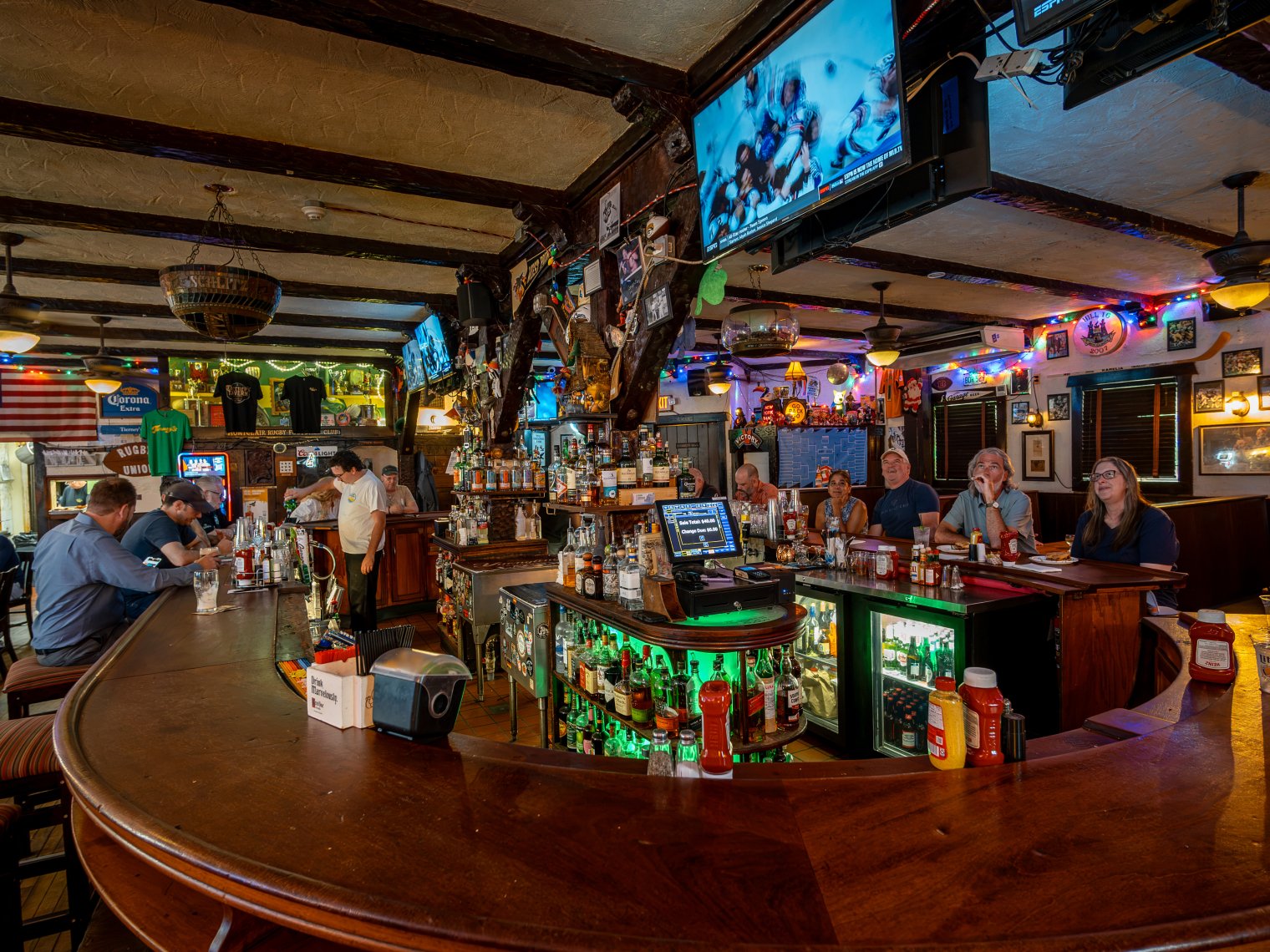 Patrons sit around a bar at Tierney’s. 