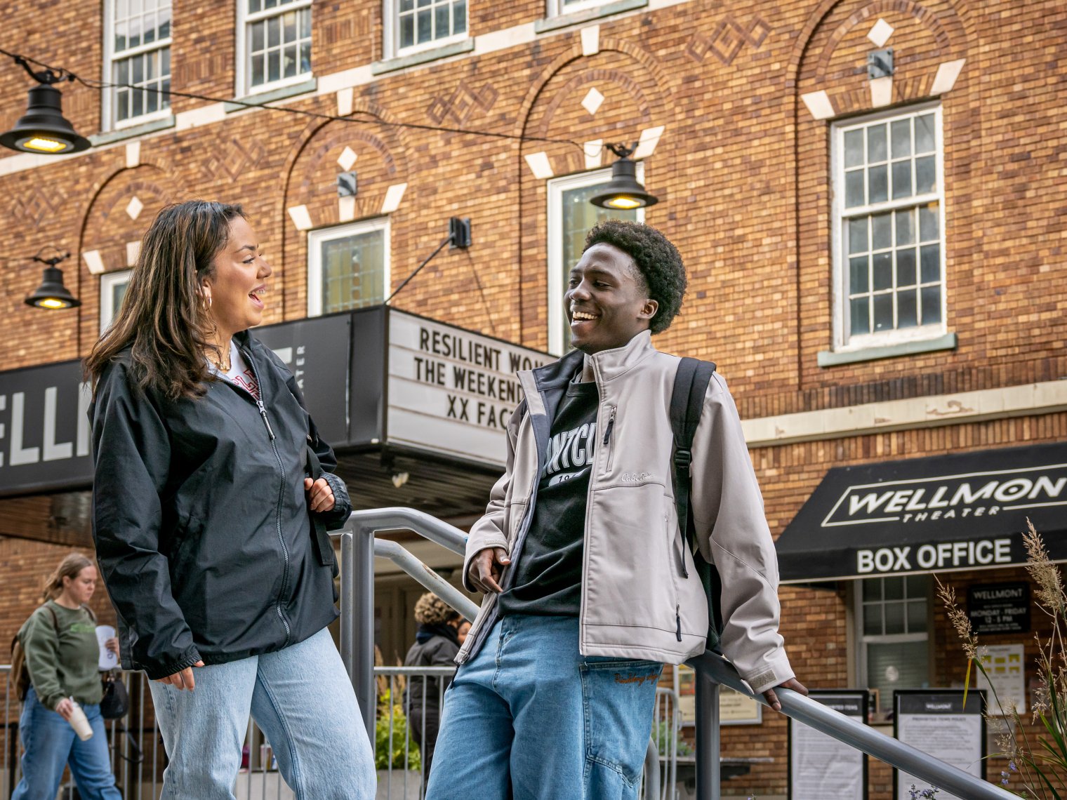 Two Montclair students stand in front of the Wellmont Theater.