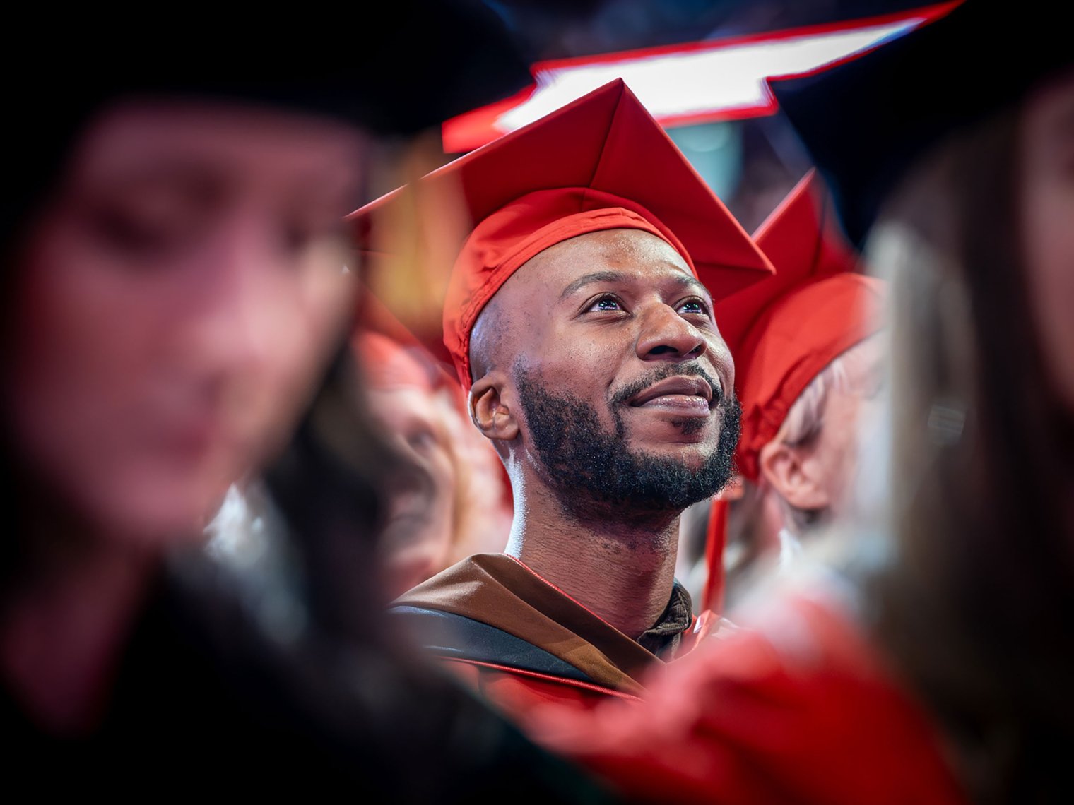 Malcolm McMichael in red cap and gown at Montclair State University 2026 Commencement.