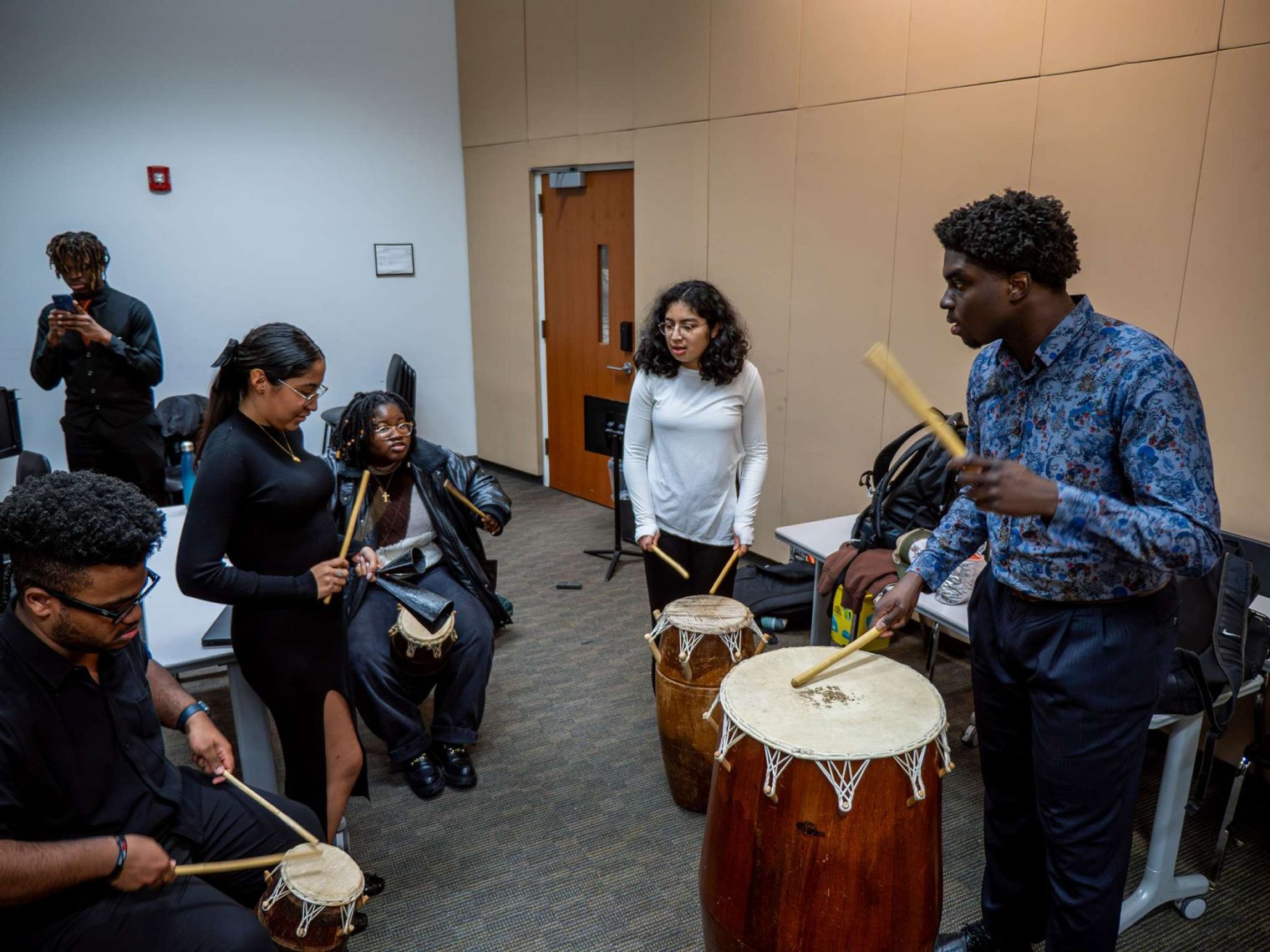 Students rehearsing drumming before Hues Performance