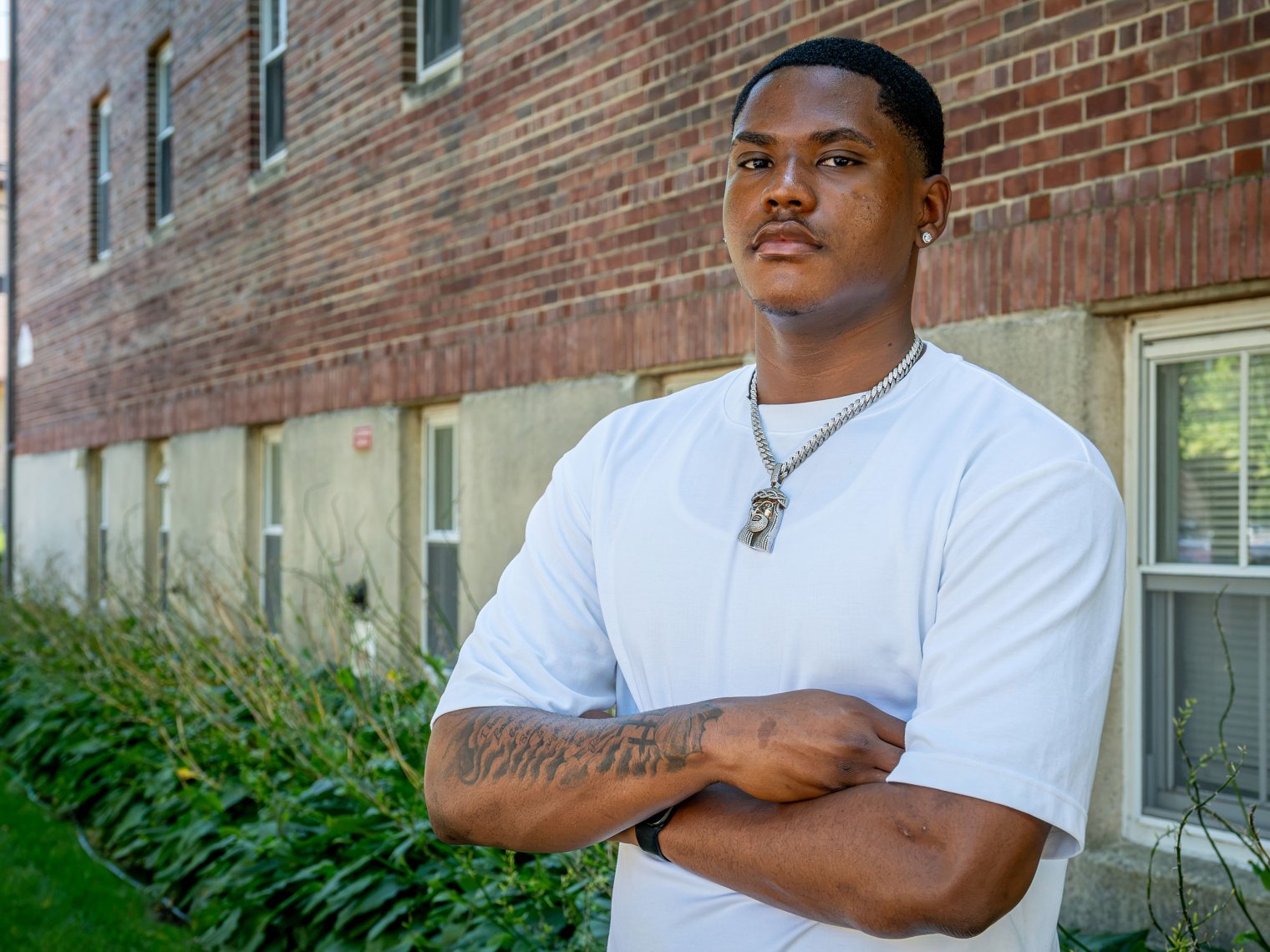 Student Johno Harrison poses outside next to building on Bloomfield campus