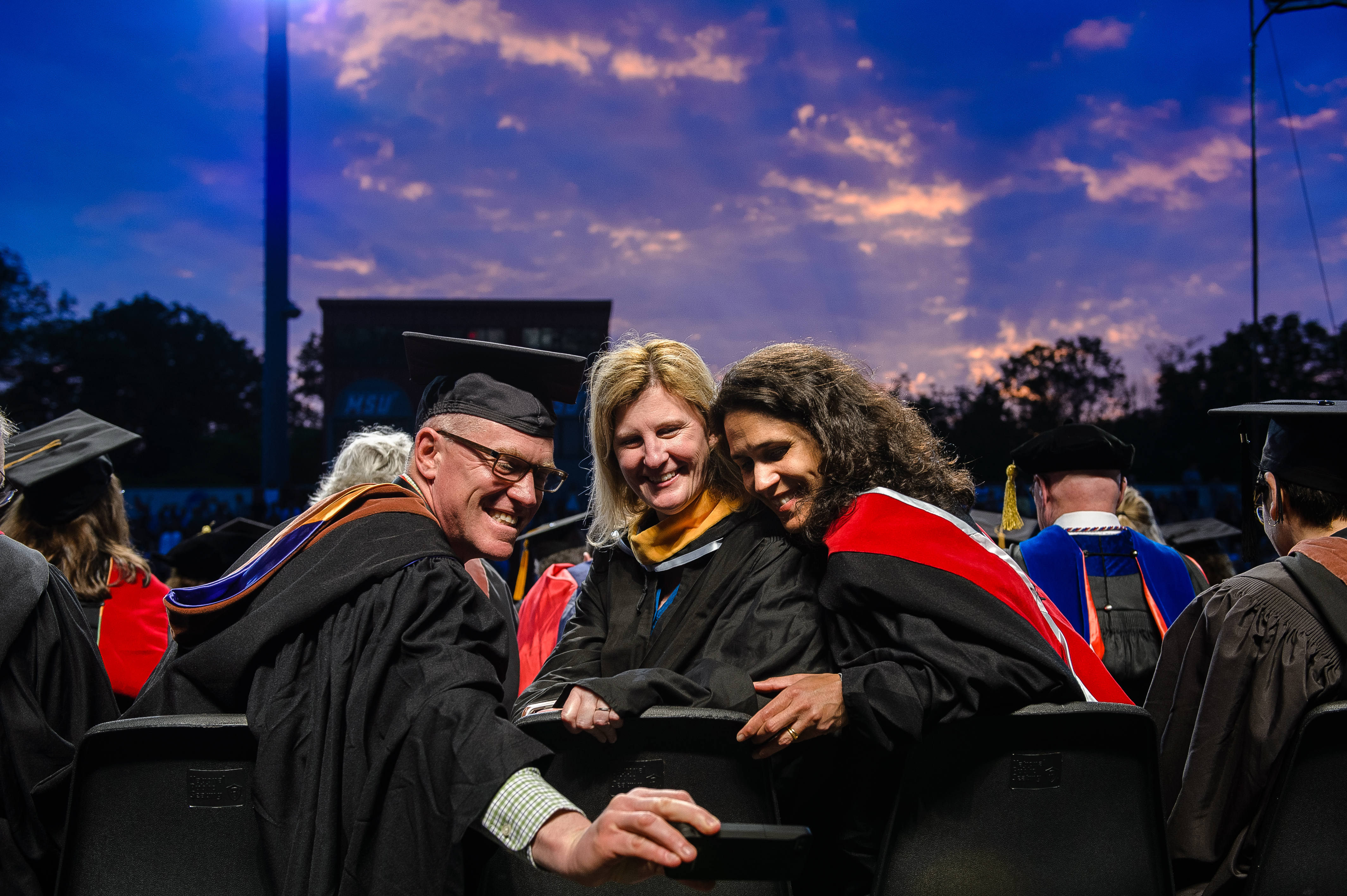 School of Communication and Media faculty Thomas Franklin, Kelly Whiteside, and Tara George at the 2016 College of the Arts Convocation.