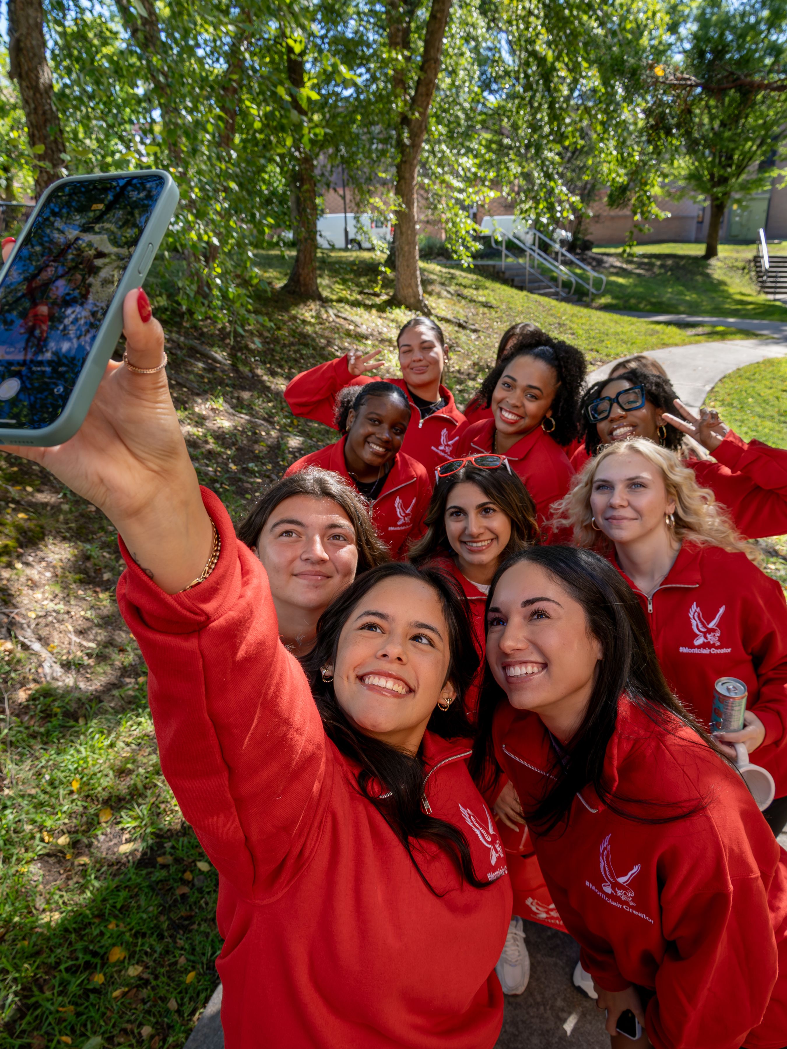 A group of social media ambassadors pose for a high-angle selfie