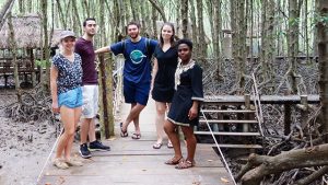 Photo of students in remote wooded village.