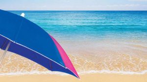photo of sandy beach, ocean and umbrella